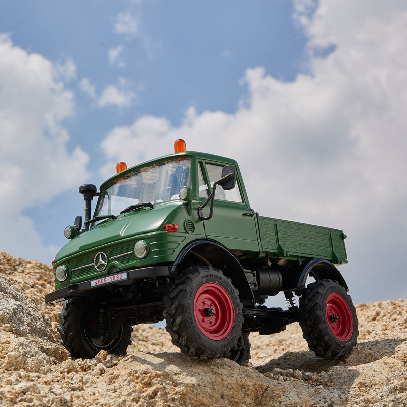 Green Mercedes-Benz Unimog 421 RC truck in rugged outdoor setting