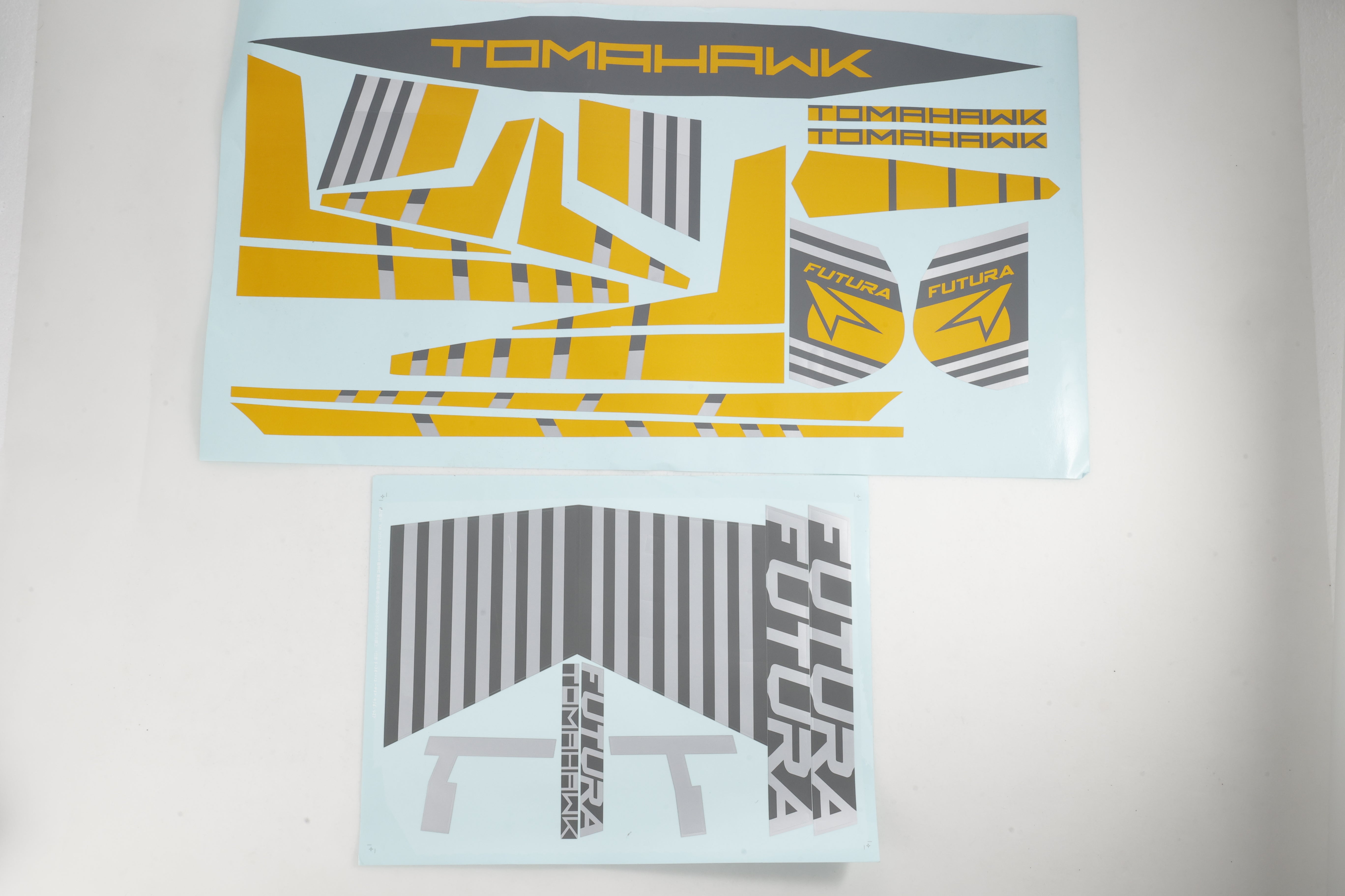 RC model stickers with 'TOMAHawk' in yellow and 'Futura' in grey designs on blue background.