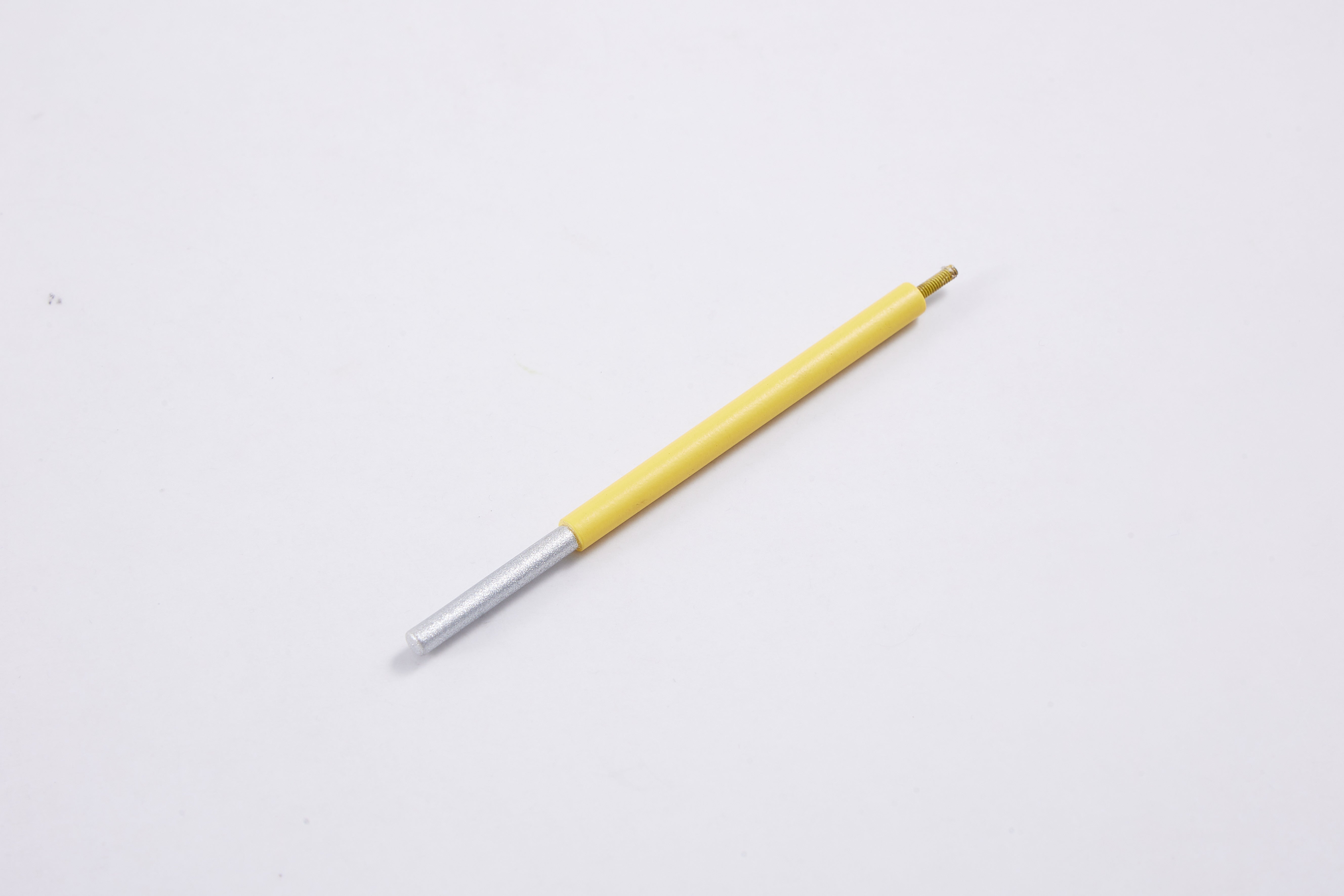 Yellow and silver pen on white background