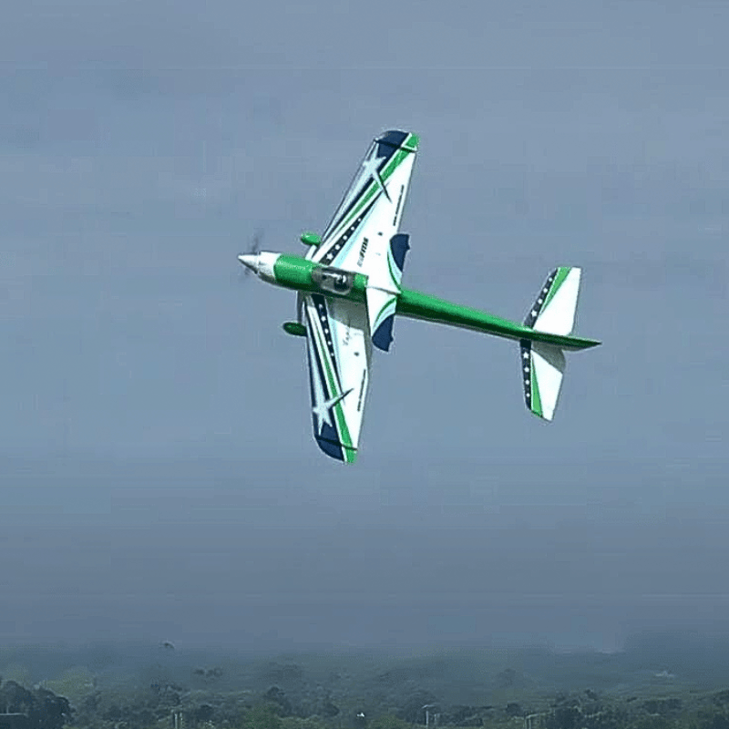 FMS F3A Explorer PNP doing aerial tricks with green and blue design.