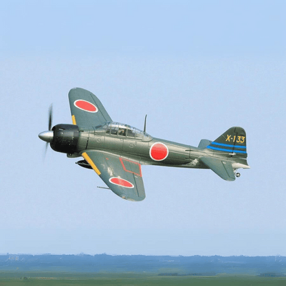 A6M3 Zero model flying with green body, red roundels, and blue tail stripes in clear skies