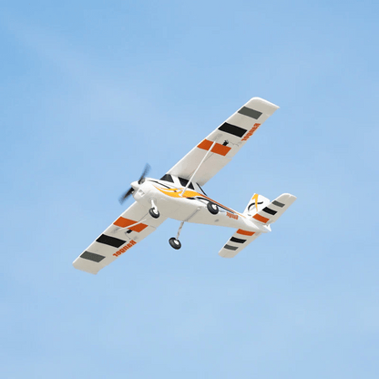 FMS 850mm Ranger RC airplane in flight, featuring bold colors and tricycle landing gear.