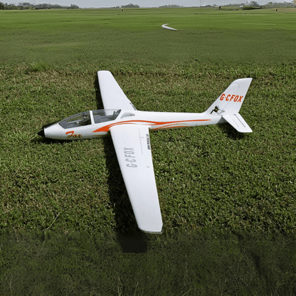 FMS 2300mm FOX V2 Glider resting on grass with orange and white design